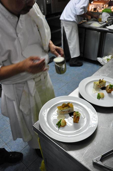 Bocuse d'Or Candidate Chef Ariel Manuel puts the finishing touches on the plate